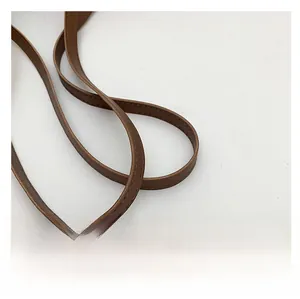 Detail of brown leather straps with fine stitching on a vintage leopard tote bag