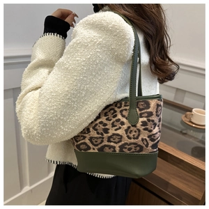 Detail of trendy leopard print stitching shoulder bag worn by model in a daily scene