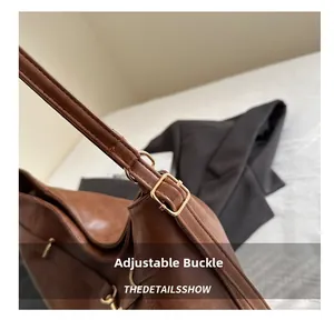 Close-up of adjustable strap buckle on a vintage brown leather tote bag with gold hardware
