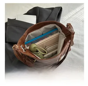 Interior view of large dark brown tote bag showing capacity for umbrella and wallet
