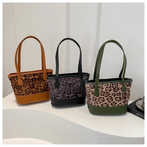 Detailed view of large leopard print bucket bags in brown, grey, and olive green