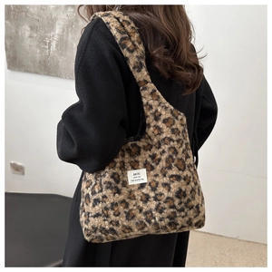 Detail of soft leopard print plush tote bag showing fluffy texture and trendy brand label