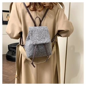 Detail of wool fabric backpack texture with leather drawstring and elegant shoulder straps