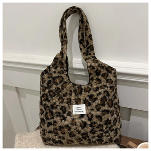 Detail of soft leopard print faux fur tote bag with a white square fabric brand label