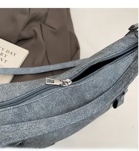 Close-up of smooth metal zipper and grey snowflake textured fabric on tote bag