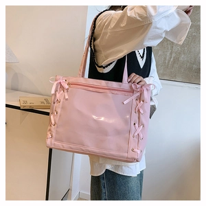 Pink ita bag with clear PVC window and cross-ribbon lace-up details on side