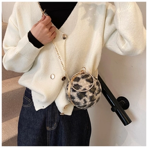 Detail of plush leopard print spherical bag featuring rhinestone-studded ring handle