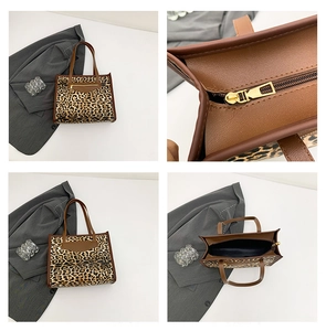 Detail view of leopard print tote bag showing stitching, gold zippers and interior lining