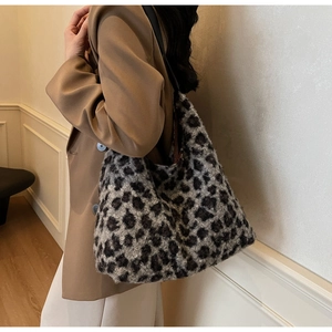 Detailed close-up of plush leopard print faux fur texture on a large hobo tote bag