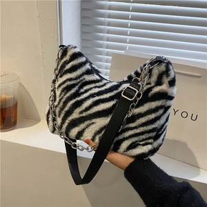 Plush zebra print tote bag with soft faux fur texture and silver metal chain strap