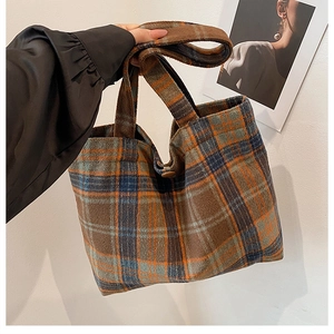 Detail of vintage plaid wool tote bag showing thick fuzzy texture and button closure