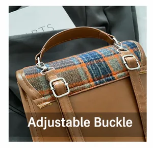 Detail of adjustable buckle and brown plaid wool texture on stylish crossbody bag