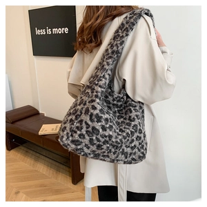 Detail of plush leopard print tote bag with soft faux fur texture and wide shoulder strap