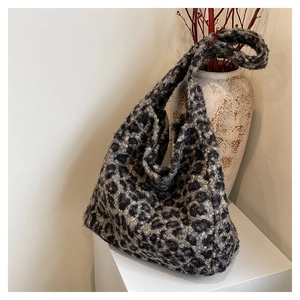 Close-up of leopard print faux fur tote bag showing plush texture on a white pedestal