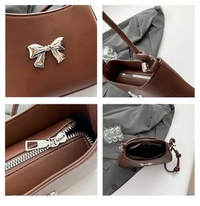 Detailed macro view of silver metallic bow ornament and smooth brown leather texture