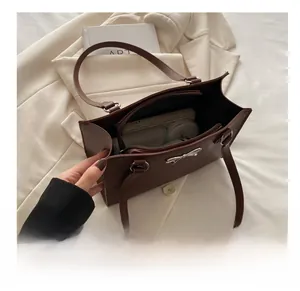 Interior view of large brown tote bag showing spacious capacity and inner pocket