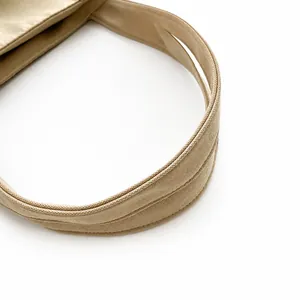 Detail shot of beige nylon tote bag showing durable shoulder strap stitching and fabric