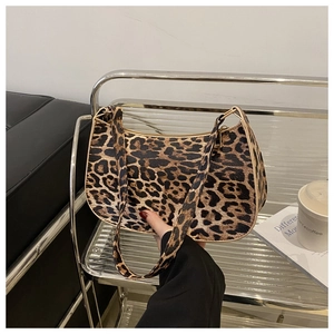 Close-up of leopard print shoulder bag featuring smooth PU leather and a metal zipper