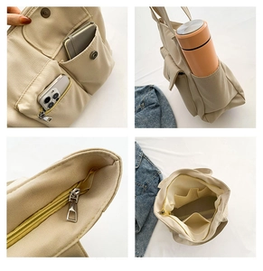 Detail view of nylon tote bag with multi-pocket storage and durable zipper closure