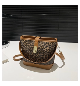 Detailed view of the leopard print bucket bag featuring a golden metal twist lock closure