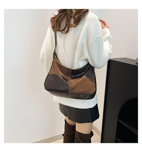 Close-up of retro hobo bag with contrast color stitching and matte leather texture