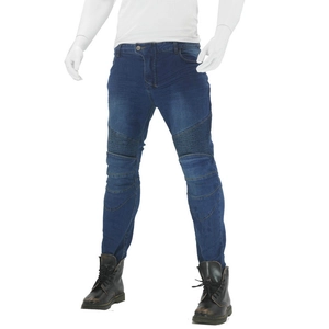 Detail of dark blue denim moto pants featuring pleated knee panels and slim fit design