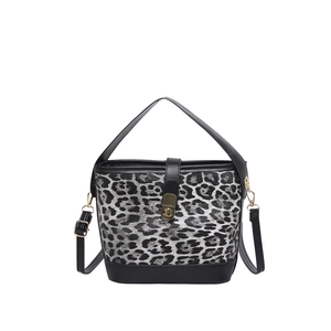 Stylish leopard print bucket bag with black leather straps and gold metal hardware
