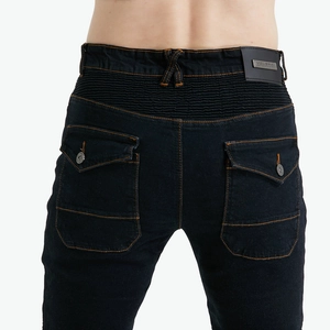 Detail of accordion stretch panels and orange contrast stitching on motorcycle jeans