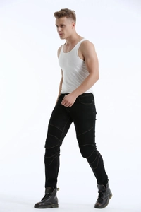 Detail of reinforced accordion ribbing and brown contrast stitching on black biker jeans
