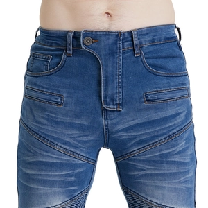 Detailed close-up of dark blue moto denim jeans with ribbed panels and whiskered texture