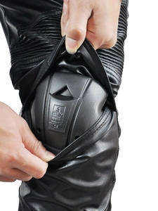 Detail showing inner CE certified knee armor inside black leather motorcycle pants