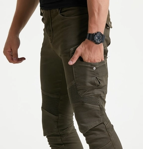 Close-up of military green motorcycle pants with accordion stretch panels and side cargo pockets