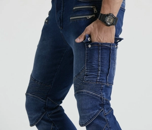 Detail of blue motorcycle denim pants with accordion stretch panels and metal zipper pockets