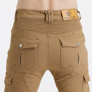 Detail of khaki motorcycle jeans featuring accordion stretch panels and leather moto label