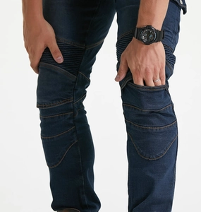 Detail of dark blue motorcycle jeans with accordion stretch panels for knee flexibility