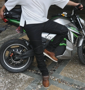 Detail of black motorcycle riding jeans showing stretch accordion panels and knee protection