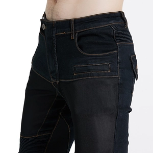 Dettaglio dei jeans da moto con pannelli in rete traspirante e cuciture arancioni a contrasto