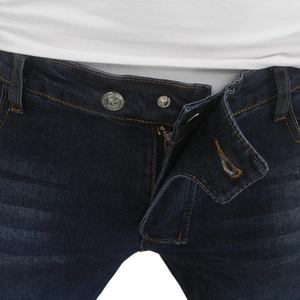 Detail of motorcycle denim jeans waist with double embossed metal buttons and zipper fly