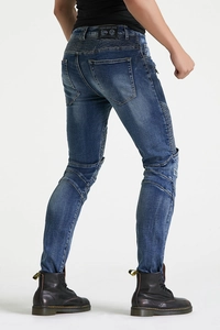 Rear view of vintage motorcycle jeans featuring accordion stretch panels and washed denim