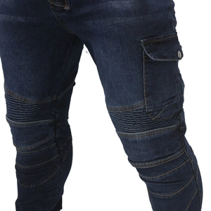 Detail of blue denim motorcycle jeans with reinforced knee pleats and utility pockets