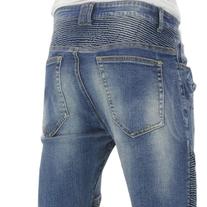 Detail of blue motorcycle jeans featuring retro pleated accordion stretch panels and stitching