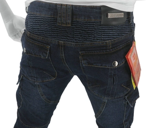 Detail of blue motorcycle jeans featuring protective accordion stretch panels and leather logo