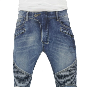 Macro detail of retro washed blue motorcycle jeans with ribbed knee panels