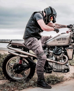 Side view of motorcycle cargo riding jeans with protective knee pleats on coastal road