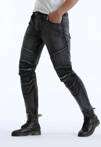 Detail of biker jeans showing protective pleated knee panels and washed denim texture