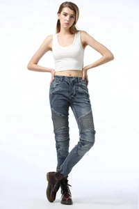Detail view of motorcycle jeans for women with pleated knee stretch panels in dark blue wash