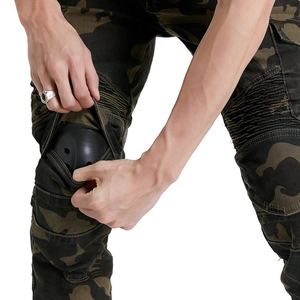 Detail of installing knee pads into camouflage motorcycle riding pants for extra safety