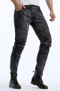 Close-up of vintage grey biker jeans with protective knee pleats and washed texture
