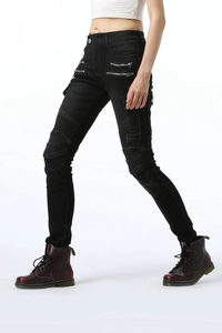 Close-up of women's black biker pants with pleated knee panels and metal zippers