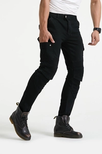 Detail of black motorcycle cargo pants featuring pleated knee panels and side snap pockets